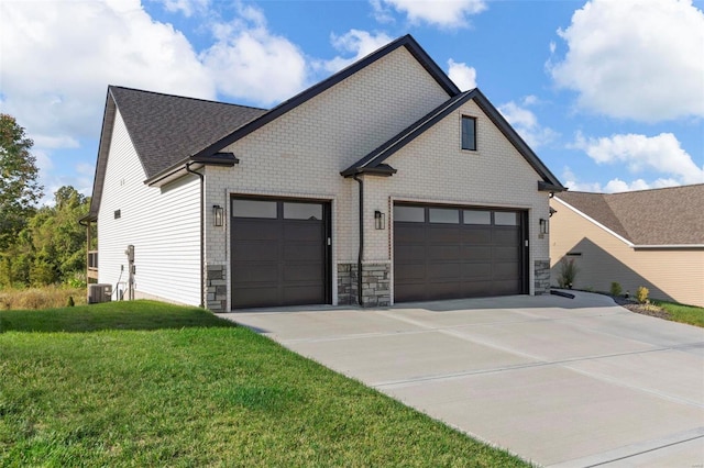 view of front of house with cooling unit, a front lawn, and a garage