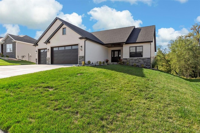 view of front of property featuring a front yard and a garage