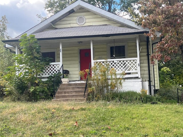 bungalow-style home with a front lawn and a porch