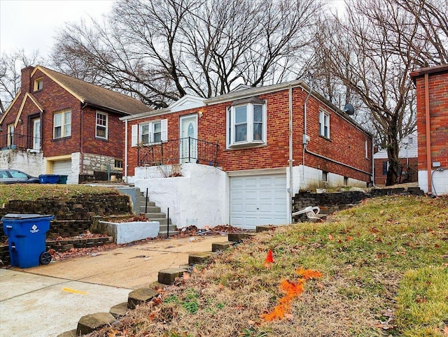 view of front of home featuring a garage, brick siding, and driveway