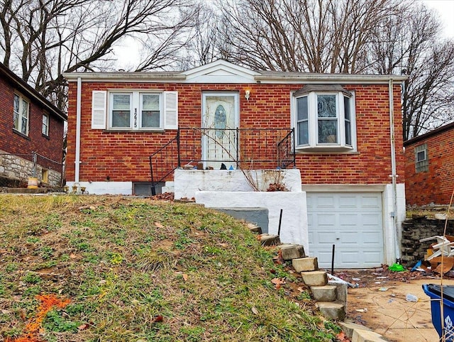 view of front of home featuring brick siding and an attached garage