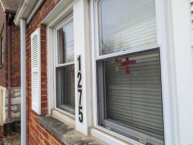 exterior details featuring brick siding