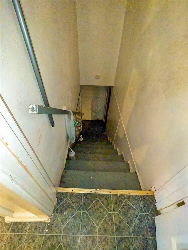 stairway with tile patterned floors