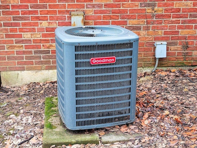 exterior details featuring brick siding and central AC unit