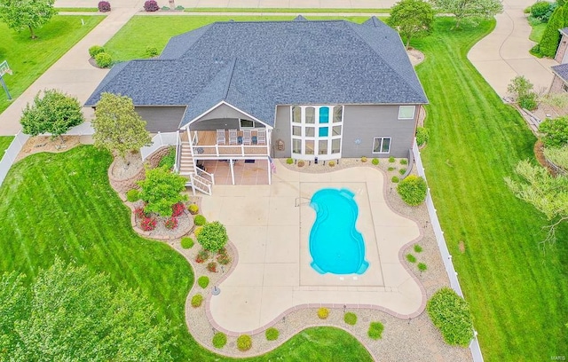 view of pool with a patio and a yard