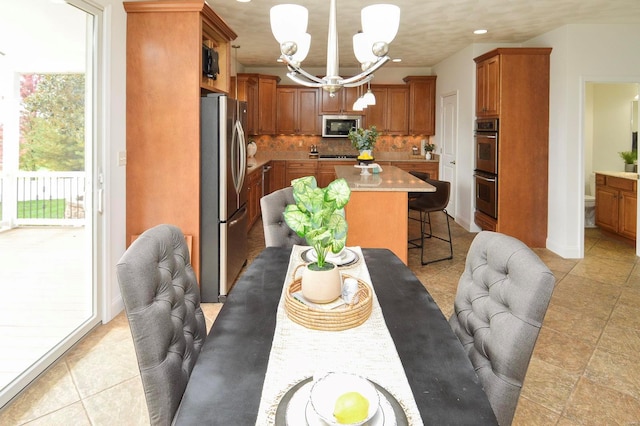 tiled dining space with an inviting chandelier