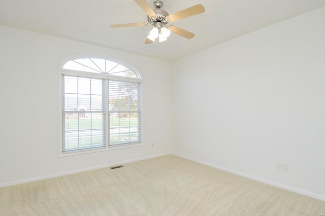 carpeted empty room featuring ceiling fan