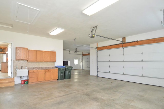 garage featuring sink and a garage door opener