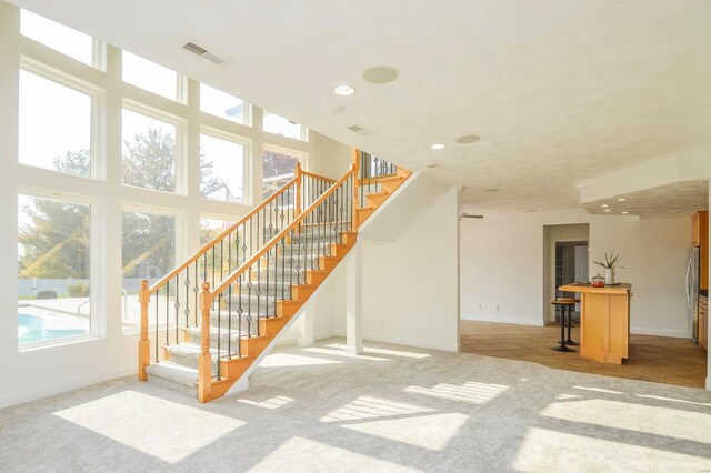 unfurnished living room featuring light colored carpet