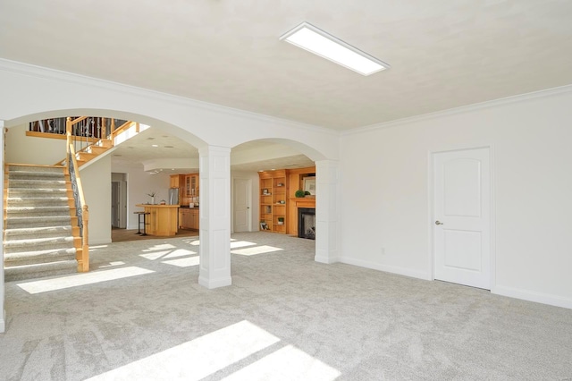 unfurnished living room with light carpet and ornamental molding