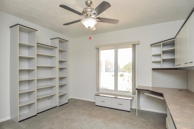 interior space featuring light carpet and ceiling fan