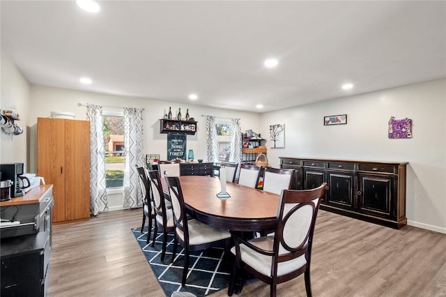 dining space with light hardwood / wood-style flooring