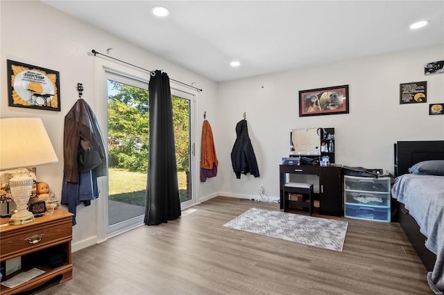 bedroom featuring light hardwood / wood-style flooring and access to outside