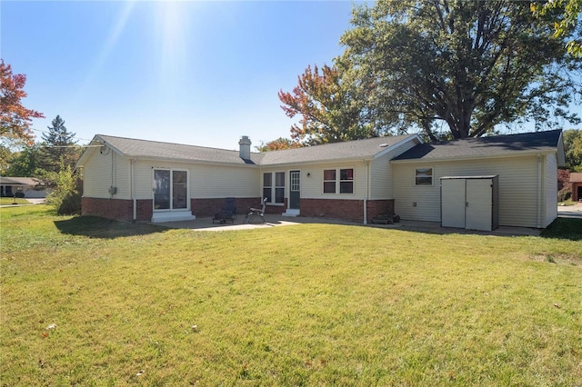 rear view of house featuring a yard and a patio