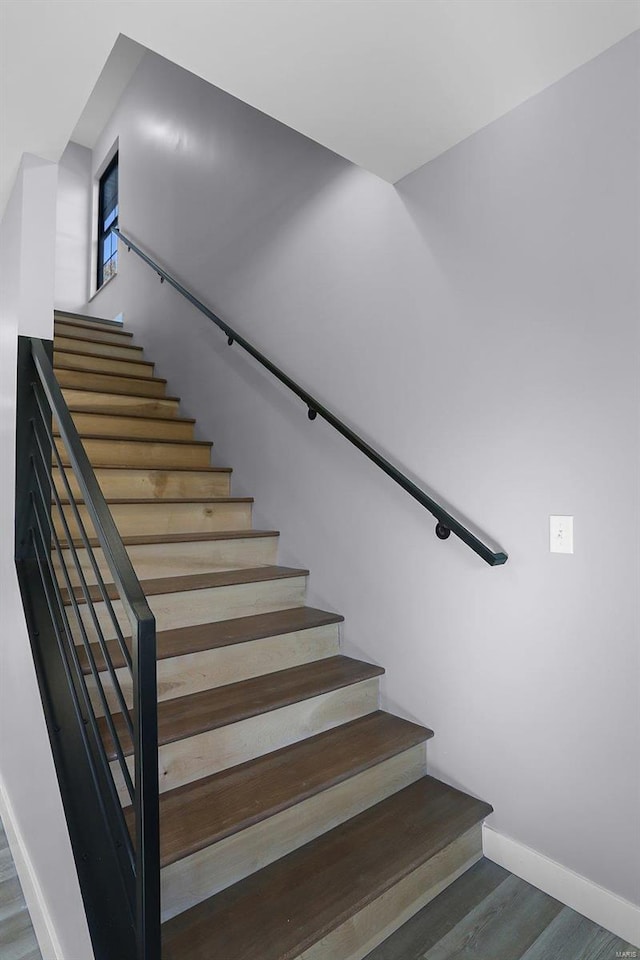 stairs featuring hardwood / wood-style floors