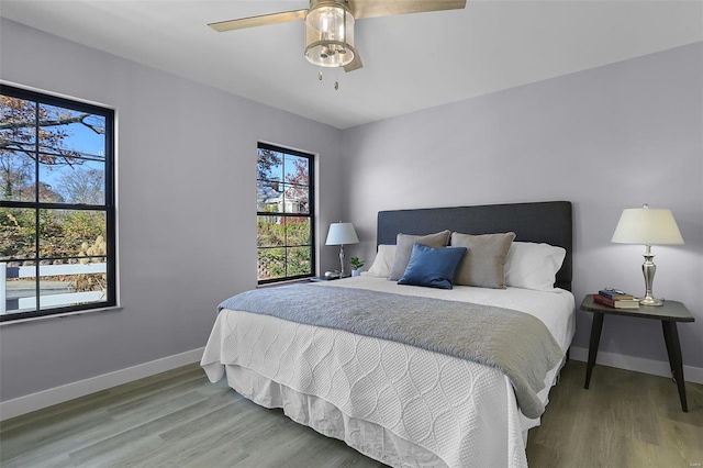 bedroom with wood-type flooring and ceiling fan