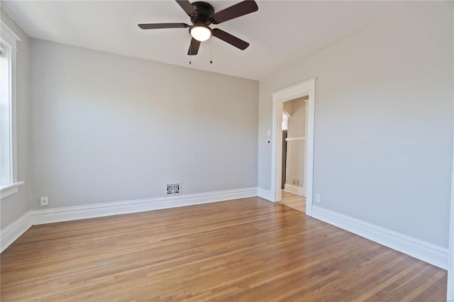 unfurnished room with a healthy amount of sunlight, light wood-type flooring, and ceiling fan