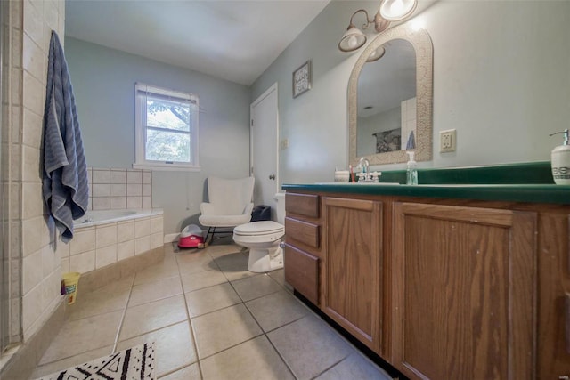 bathroom with vanity, toilet, tiled bath, and tile patterned floors