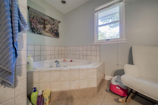 bathroom with tile patterned floors and tiled tub