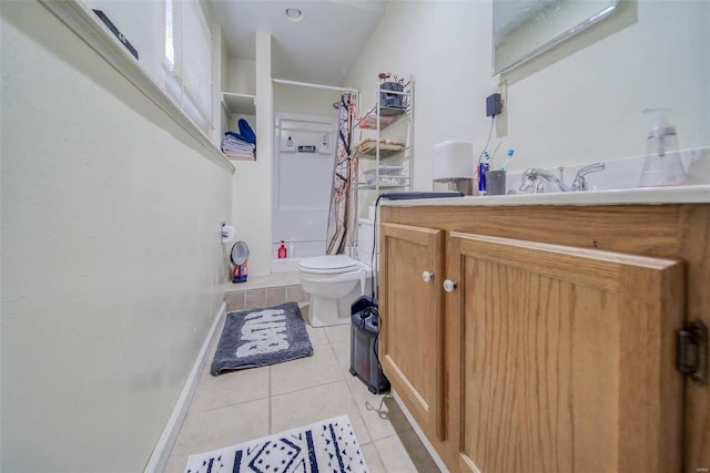 bathroom with toilet, curtained shower, vanity, and tile patterned flooring