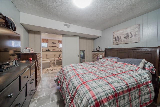 tiled bedroom featuring a textured ceiling