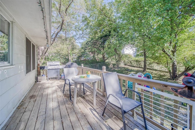 wooden terrace featuring a grill