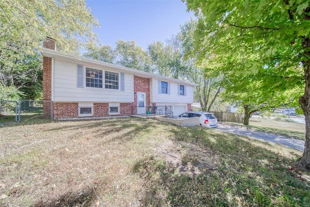 split foyer home with a front lawn