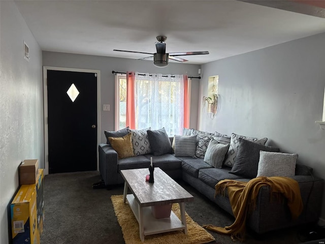 carpeted living room with ceiling fan