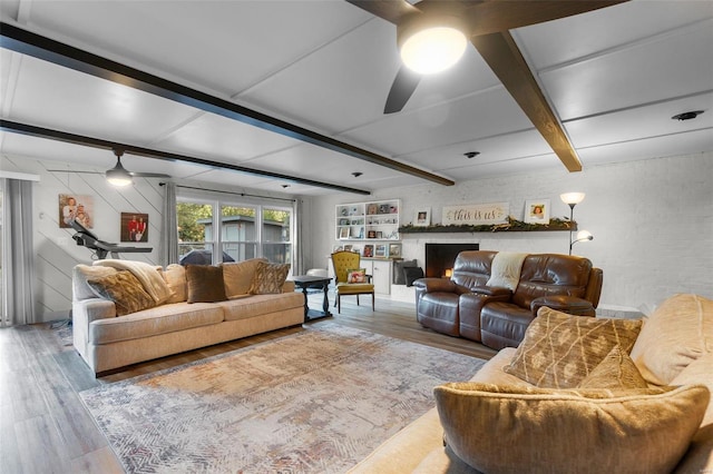 living room with wood-type flooring, ceiling fan, and beam ceiling