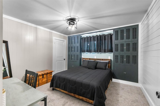 carpeted bedroom with wood walls and ornamental molding