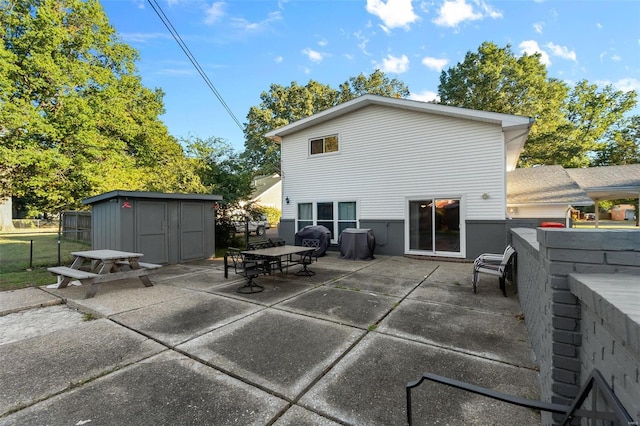 rear view of house with a shed and a patio area