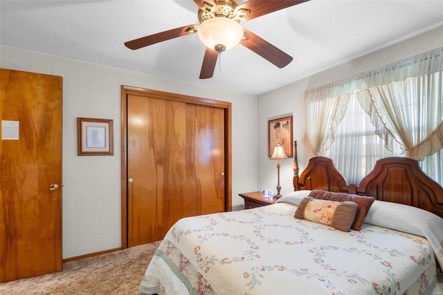 bedroom featuring light carpet, a closet, and ceiling fan