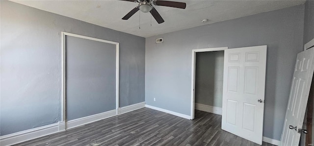 unfurnished bedroom featuring a closet, ceiling fan, and dark hardwood / wood-style flooring