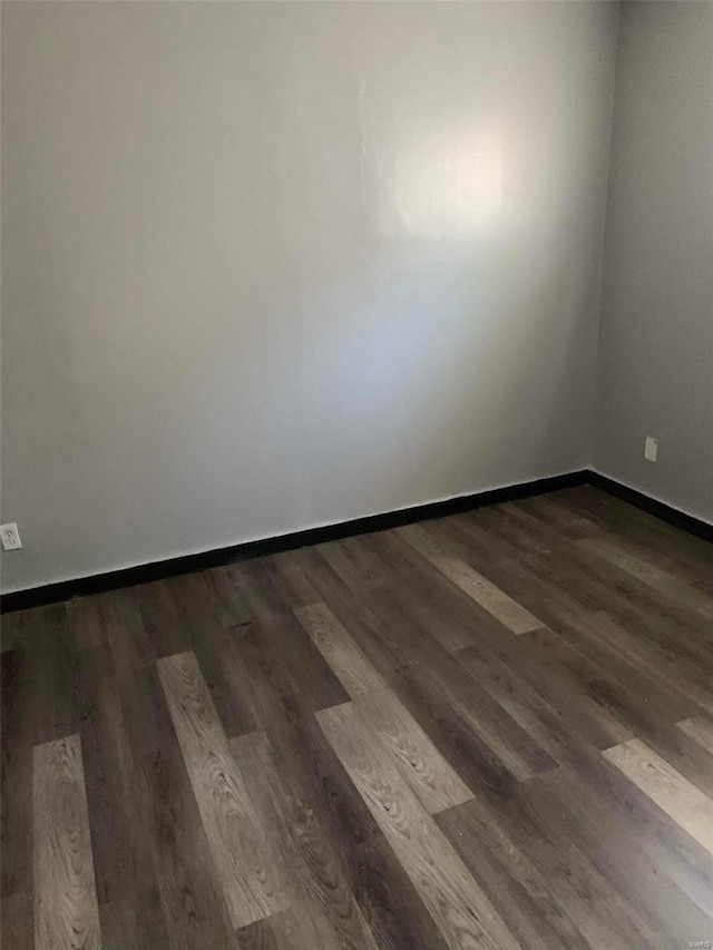 unfurnished room featuring dark hardwood / wood-style floors