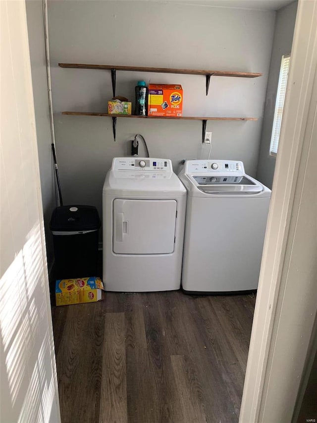 washroom featuring washing machine and dryer and dark hardwood / wood-style floors