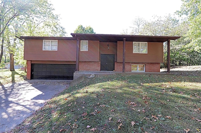 view of front of property with a front yard and a garage