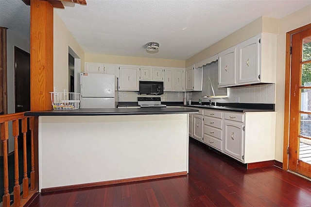 kitchen featuring white cabinetry, dark hardwood / wood-style floors, and white appliances