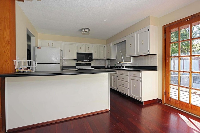 kitchen featuring dark hardwood / wood-style flooring, white cabinets, tasteful backsplash, and white refrigerator