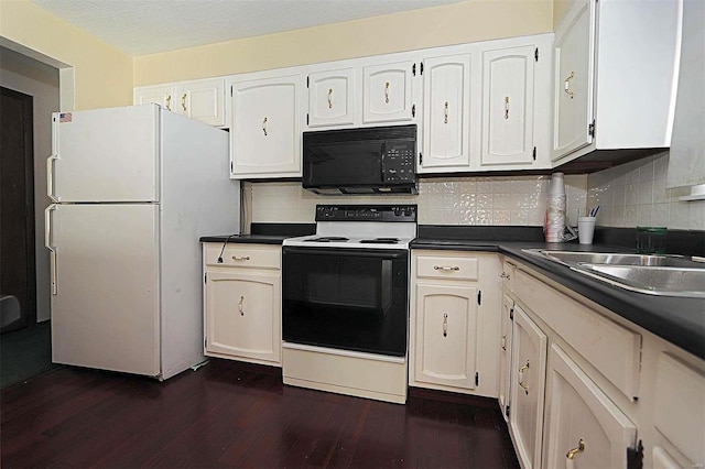 kitchen featuring dark hardwood / wood-style flooring, white cabinetry, and white appliances