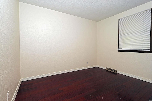 unfurnished room with hardwood / wood-style floors