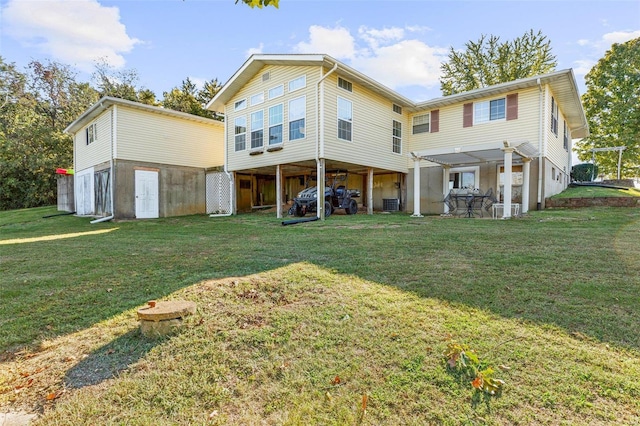 rear view of house featuring a lawn