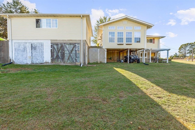 back of property featuring a yard and an outdoor structure