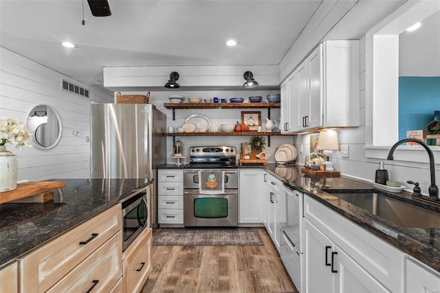 kitchen featuring white cabinets, dark hardwood / wood-style flooring, stainless steel appliances, and sink