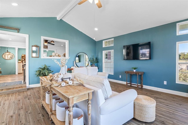 living room with lofted ceiling with beams and hardwood / wood-style flooring