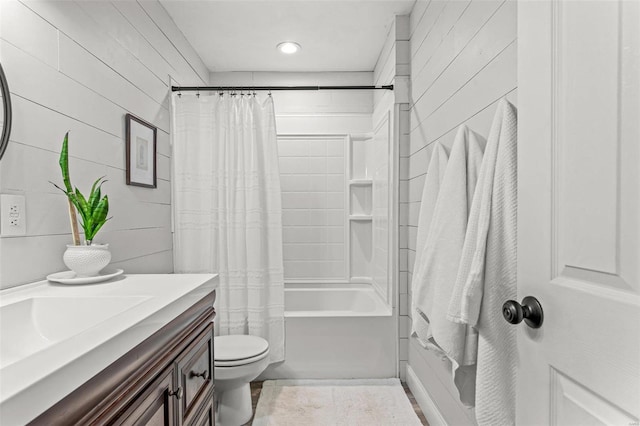 full bathroom with shower / bath combination with curtain, toilet, and vanity