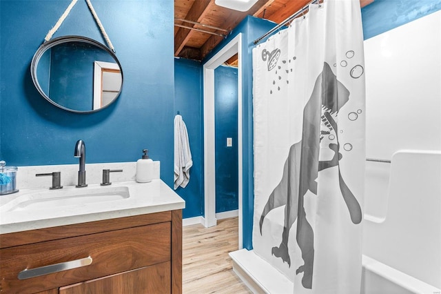 bathroom with hardwood / wood-style floors, vanity, a shower with curtain, and wooden ceiling