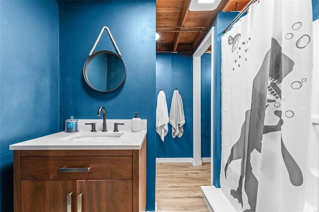 bathroom with hardwood / wood-style floors, vanity, and wooden ceiling