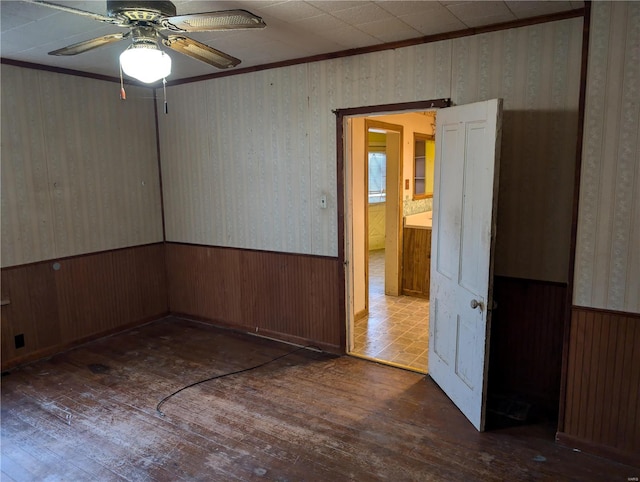 spare room with ceiling fan, crown molding, and dark hardwood / wood-style floors