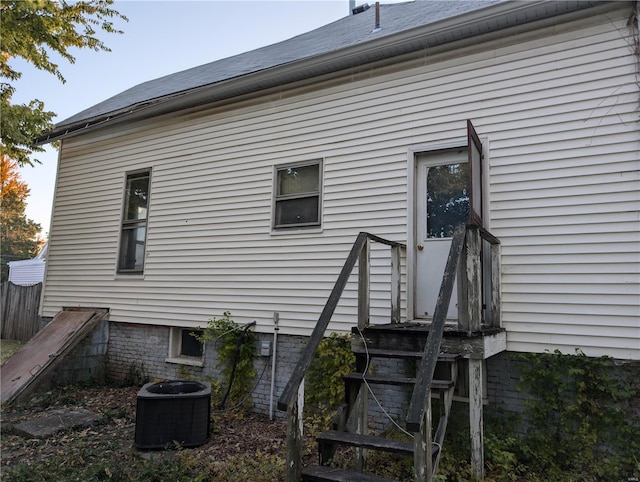 rear view of house featuring central AC