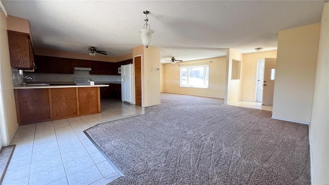 kitchen with electric stove, a textured ceiling, white refrigerator with ice dispenser, light carpet, and pendant lighting